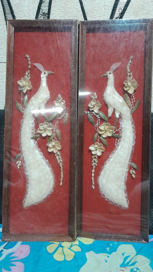 Pair of Framed Bird Wall Art (Category: Everything Else Others) located in Quezon City. Submitted by suziemarcos (Listing ID 1434694615, Image 1). Description: - Set of two framed wall art pieces. - Features bird designs with long tails and floral accents. - Artwork set against a red background. - Frames are wooden and rectangular. - Each frame has a clear cover. - Approximate dimensions: 24 inches (length) x 8 inches (width). These are examples 