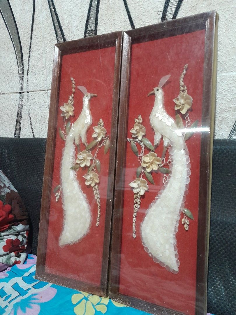 Pair of Framed Bird Wall Art (Category: Everything Else Others) located in Quezon City. Submitted by suziemarcos (Listing ID 1434694615, Image 3). Description: - Set of two framed wall art pieces. - Features bird designs with long tails and floral accents. - Artwork set against a red background. - Frames are wooden and rectangular. - Each frame has a clear cover. - Approximate dimensions: 24 inches (length) x 8 inches (width). These are examples 