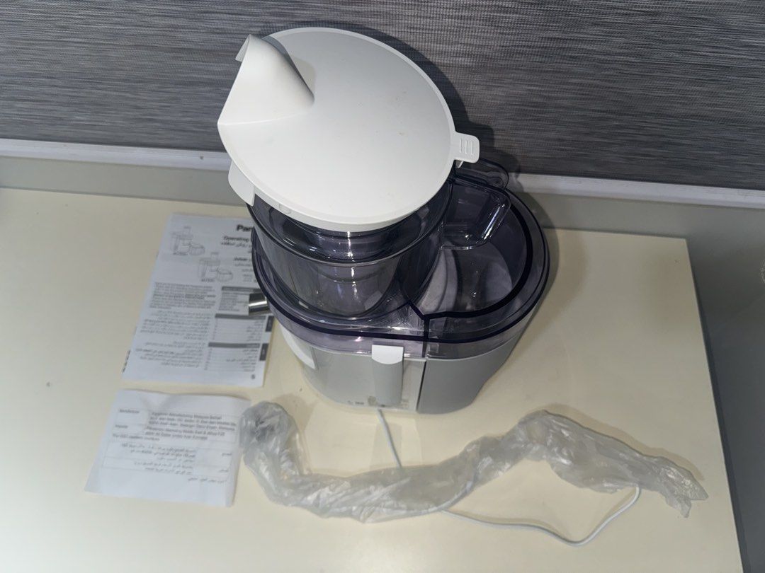 [LIKE NEW] Panasonic Juicer MJ-DJ01 (Category: Juicers, Blenders & Grinders) located in Quezon City. Submitted by _aceys (Listing ID 1434776632, Image 1). Description: - Panasonic MJ-SJ01 juicer for sale - Includes main unit, lid, and instruction manual - Original plastic wrapping on power cord - Model number: MJ-SJ01 - Color: White and gray.