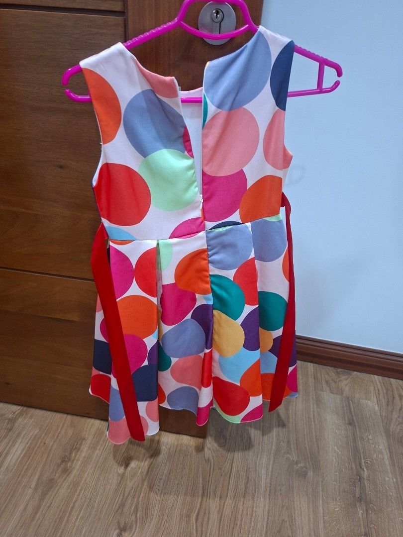 Polka Dot Dress with Red Ribbon (Category: Babies & Kids Fashion) located in Manila. Submitted by kitto222 (Listing ID 1434671730, Image 2). Description: - Vibrant polka dot dress - Features a red ribbon tie at the back - Sleeveless design - Pleated skirt - Made of lightweight material .
