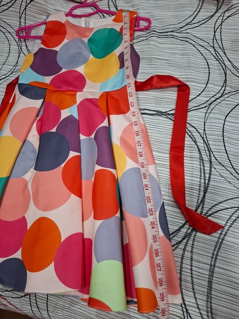 Polka Dot Dress with Red Ribbon (Category: Babies & Kids Fashion) located in Manila. Submitted by kitto222 (Listing ID 1434671730, Image 3). Description: - Vibrant polka dot dress - Features a red ribbon tie at the back - Sleeveless design - Pleated skirt - Made of lightweight material .