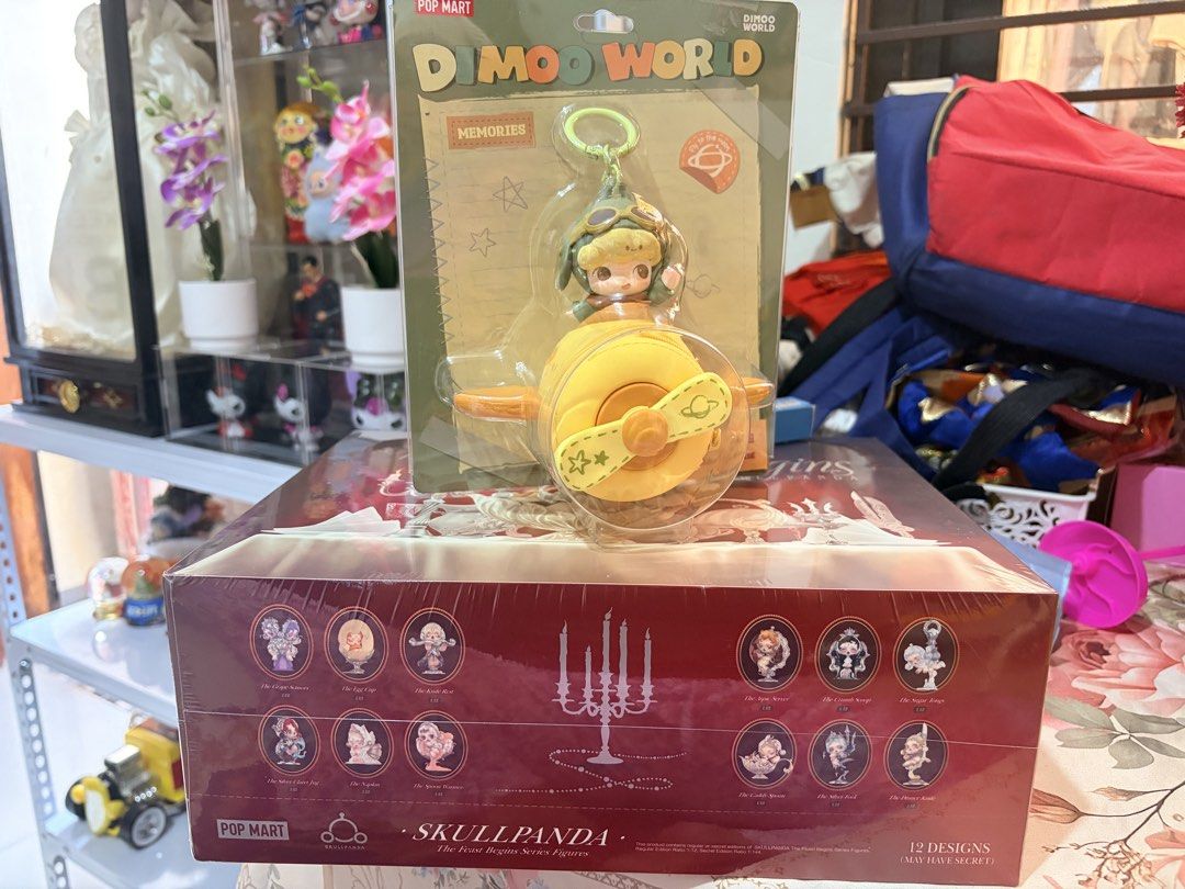 Pop Mart Dimoo World Memories Keychain (Category: Designer & Blind Box Toys) located in Nagcarlan. Submitted by kateelove09 (Listing ID 1434705147, Image 1). Description: - Pop Mart Dimoo World Memories Keychain - Features a Dimoo figure in an airplane - Brand new, unopened - Packaging includes images of Skullpanda The First Began Series figures (12 designs in total).