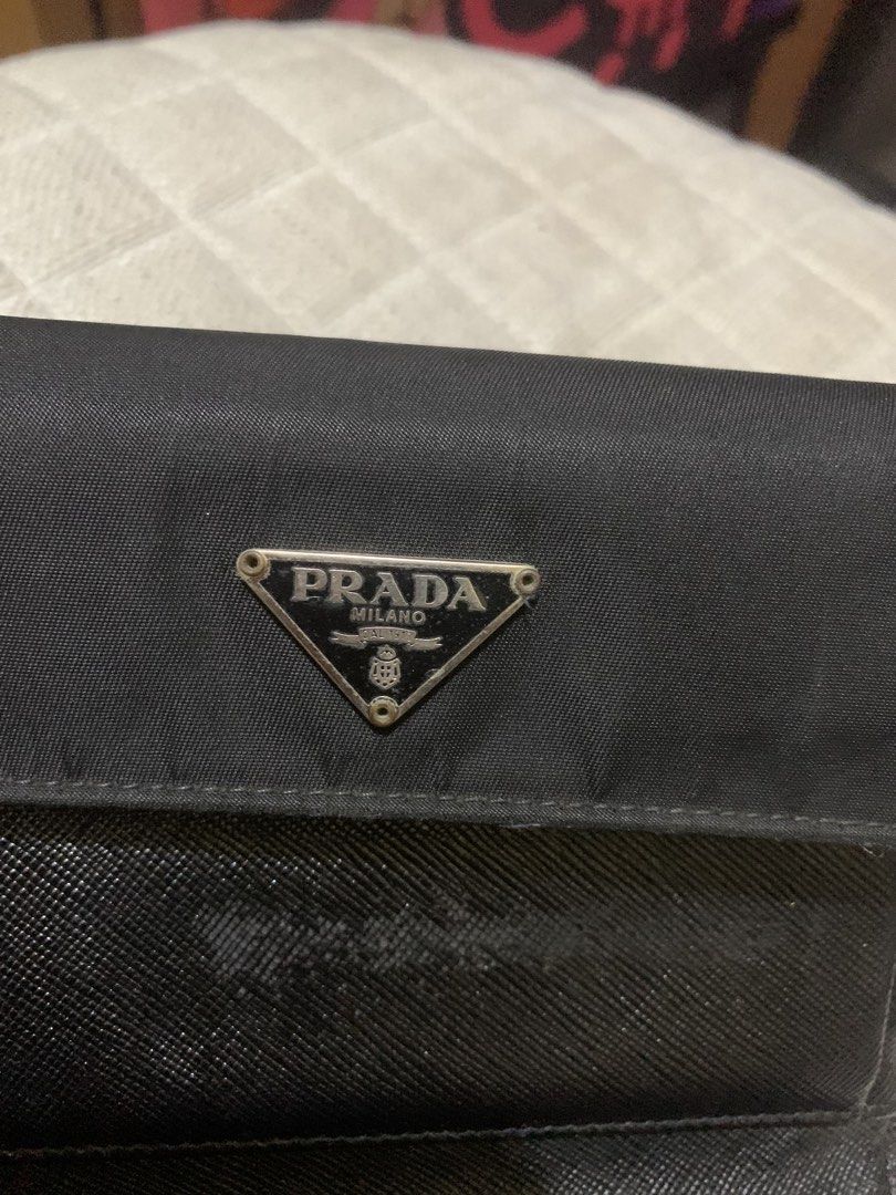 Prada Black Wallet (Category: Luxury Bags & Wallets) located in Quezon City. Submitted by ncjnc (Listing ID 1434738275, Image 2). Description: - Authentic Prada wallet - Features iconic triangular logo - Secure snap closure - Multiple compartments for cards and cash - Includes a coin pocket - Made with durable nylon and leather.
