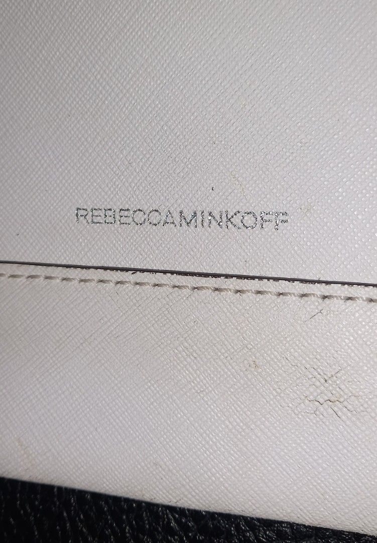 Rebecca Minkoff White Clutch (Category: Clutches) located in Cagayan de Oro. Submitted by edwardryan01984 (Listing ID 1434805733, Image 3). Description: - Rebecca Minkoff white clutch - Zipper and flap closures - Patterned interior with multiple compartments - Snap button closure - Brand name visible.