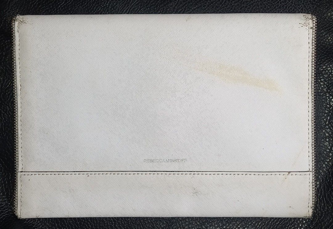 Rebecca Minkoff White Clutch (Category: Clutches) located in Cagayan de Oro. Submitted by edwardryan01984 (Listing ID 1434805733, Image 1). Description: - Rebecca Minkoff white clutch - Zipper and flap closures - Patterned interior with multiple compartments - Snap button closure - Brand name visible.