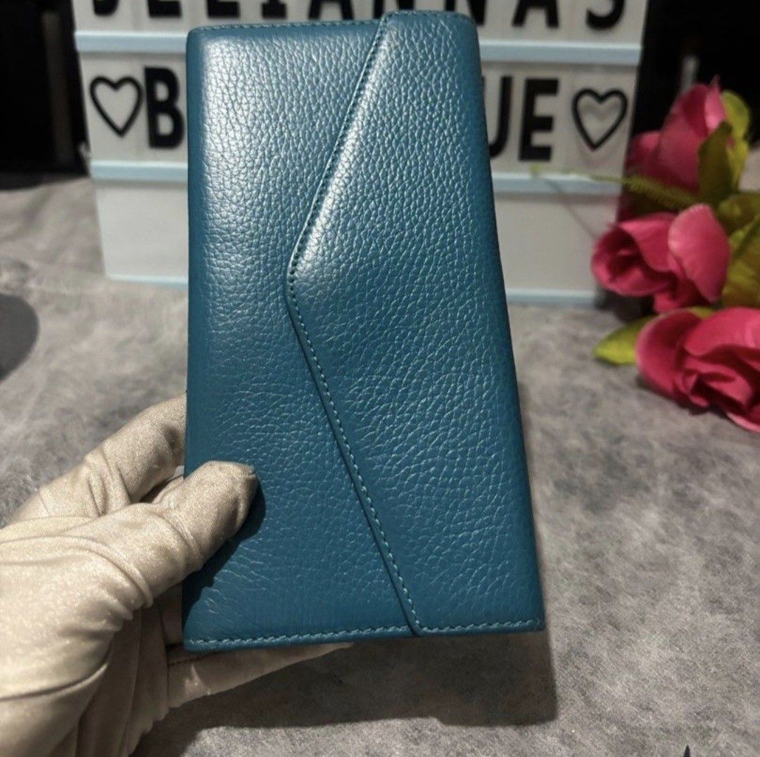 Ssamzie Teal Leather Wallet (Category: Wallets & Card holders) located in Pasig City. Submitted by khaid (Listing ID 1434680621, Image 1). Description: - Teal textured leather wallet - Multiple card slots - Clear ID window - Zippered compartment - Snap closure - Heart-shaped zipper charm - Long, slim design.