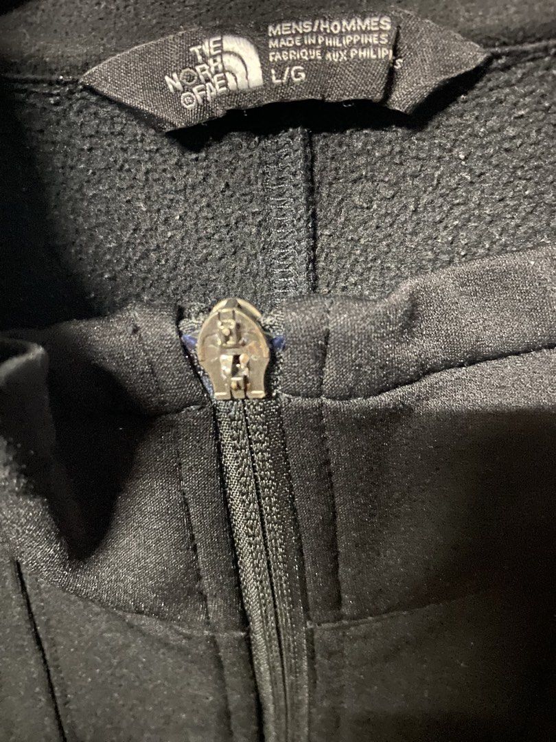 The North Face Black Jacket (Category: Coats, Jackets and Outerwear) located in Quezon City. Submitted by natesm (Listing ID 1434787724, Image 3). Description: - The North Face black jacket - Size: L/G - Features: - Full zip closure - Small logo on chest - Two side pockets - High collar - Drawstring at bottom hem issue: zipper (see picture 3).
