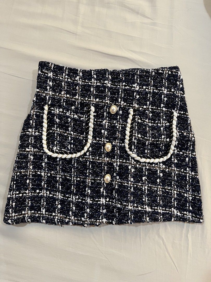 Tweed Mini Skirt with Pearl Buttons (Category: Skirts) located in Quezon City. Submitted by wem.b (Listing ID 1434673113, Image 1). Description: - Classic navy, white, and gold tweed mini skirt - Decorative pockets with white rope trim - Adorned with pearl buttons - Back zipper closure - Perfect for various occasions.