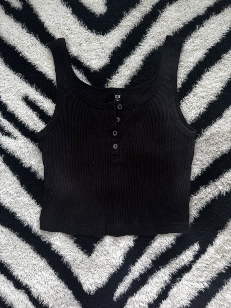 Uniqlo Black Ribbed Tank (Category: Sleeveless) located in Dumaguete. Submitted by whimsyqueen03 (Listing ID 1434053130, Image 2). Description: •In good condition •Soft stretchy ribbed fabric •Henley-style button front detail •Easy layering essential or wear on its own •Flattering fitted silhouette •Perfect basic for casual, clean girl, or capsule wardrobe styling •Pairs effortlessly with denim, cargos, and skirts • Its originally a size Large bu