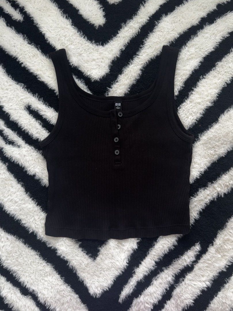 Uniqlo Black Ribbed Tank (Category: Sleeveless) located in Dumaguete. Submitted by whimsyqueen03 (Listing ID 1434053130, Image 1). Description: •In good condition •Soft stretchy ribbed fabric •Henley-style button front detail •Easy layering essential or wear on its own •Flattering fitted silhouette •Perfect basic for casual, clean girl, or capsule wardrobe styling •Pairs effortlessly with denim, cargos, and skirts • Its originally a size Large bu
