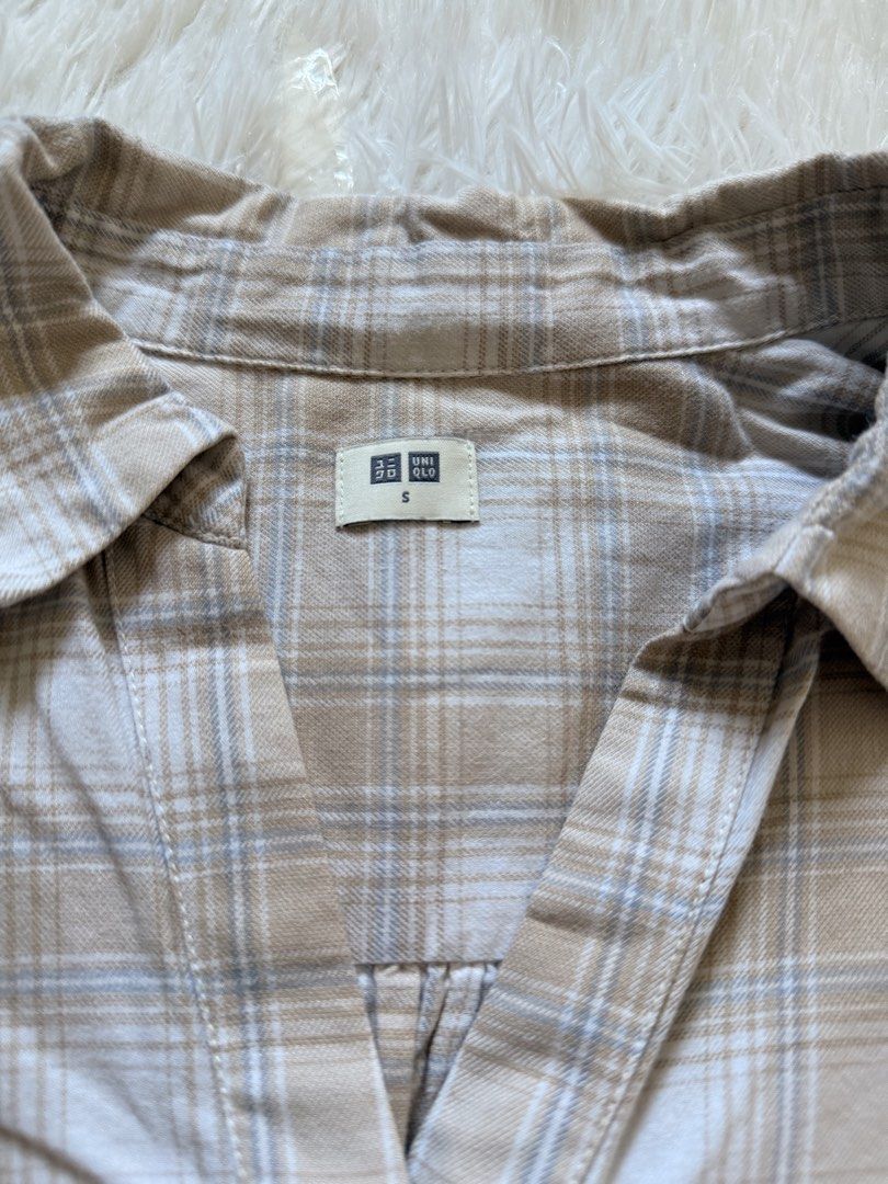 Uniqlo Plaid Shirt [PRELOVED] (Category: Others Tops) located in Manila. Submitted by yelbee (Listing ID 1434772247, Image 3). Description: - Uniqlo plaid shirt - Color: Beige and white - Size: S - Design: V-neck, long sleeves - Material: Rayon - Closure: Button - Style: Casual.