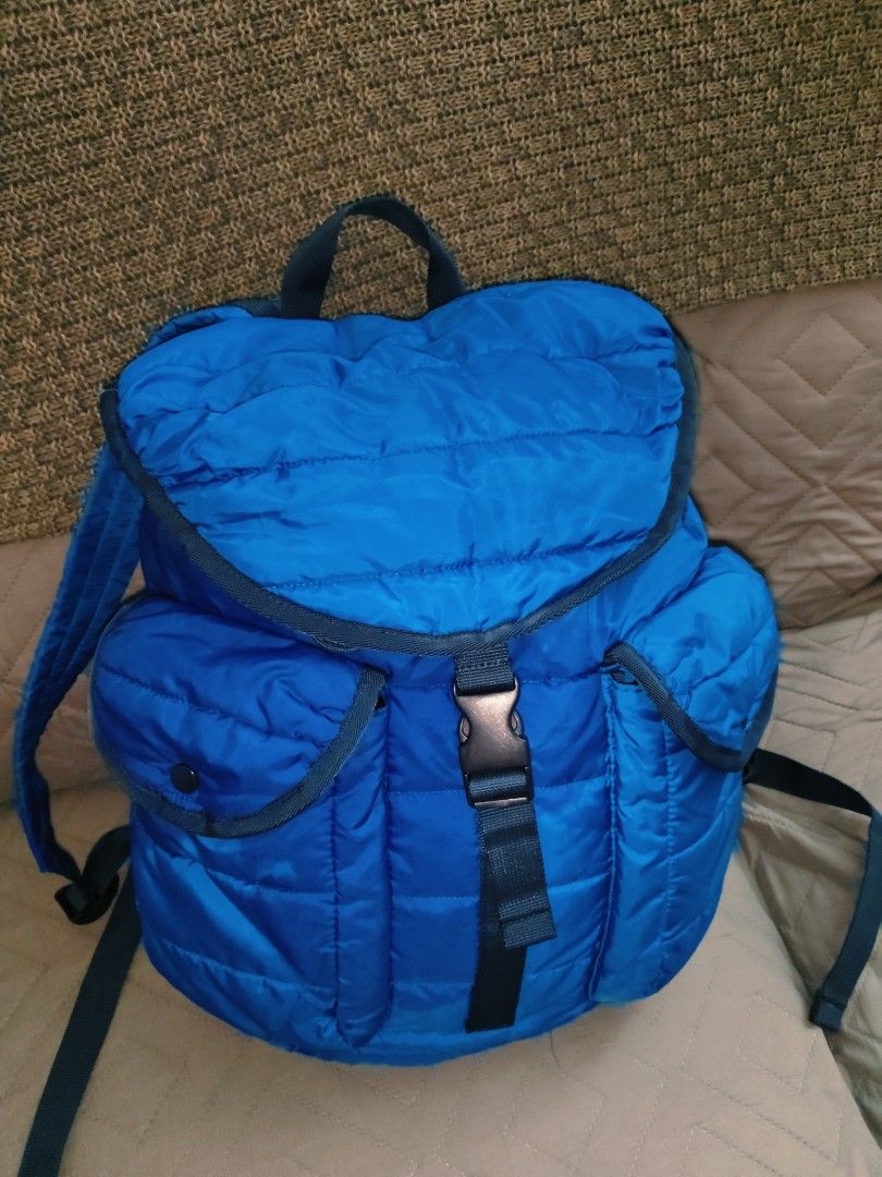 UNIQLO Quilted Backpack (Blue) - Outdoor Nylon Backpack (Category: Backpacks) located in Batangas. Submitted by kasualcornerph (Listing ID 1434691652, Image 2). Description: blue backpack with a quilted design and adjustable straps. - Color: Blue - Design: Quilting - Number of pockets: 2 front pockets - Strap: Adjustable shoulder strap - Fastening: Buckle fastening - Three interior pockets - There is a small hole (about the size of a pinhole) on 