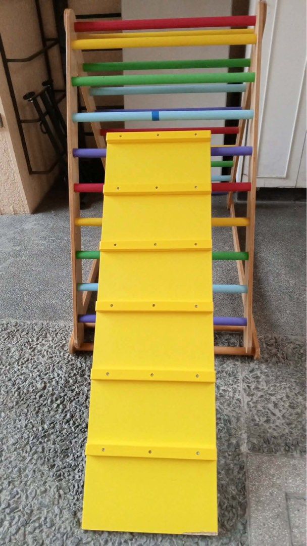 Wooden Climbing Triangle with Slide (Large Pickler) (Category: Infant Playtime) located in Paranaque City. Submitted by beagarciachoy (Listing ID 1434636415, Image 2). Description: - Wooden climbing triangle with colorful rungs. - Includes a yellow slide. - Encourages climbing and sliding for physical activity. - Improves coordination. - Sturdy and well-built frame. - Suitable for indoor and outdoor use. - Slide is easily attached and detached. -