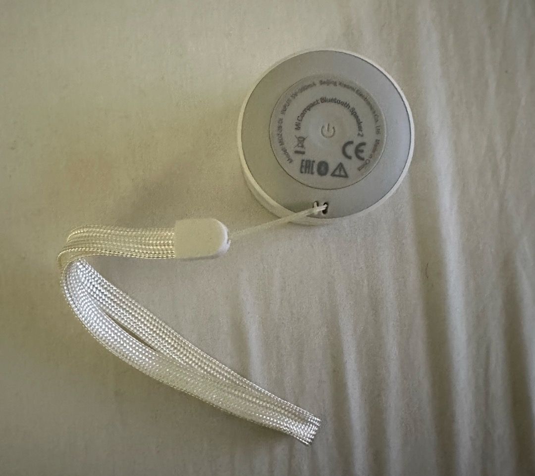 Xiaomi Mi Compact Bluetooth Speaker 2 (Category: Soundbars, Speakers & Amplifiers) located in San Juan City. Submitted by looneybin559 (Listing ID 1434627046, Image 3). Description: - Xiaomi Mi Compact Bluetooth Speaker 2 (White) - Compact and portable design - Circular shape with speaker grill - Power button located on the back - Includes a white lanyard for easy carrying - Ideal for listening to music anywhere - No box Used once. Just kept in s