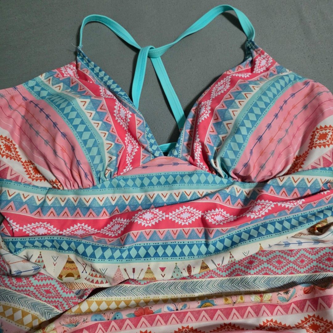 2XL Boho Print One-Piece Swimsuit (Category: Bikinis & Swimsuits) located in Manila. Submitted by plussizedpixie (Listing ID 1434750242, Image 2). Description: - One-piece swimsuit - Boho print with pink, blue, and orange accents - Halter neck design - Criss-cross straps at the back - Ruched bust detail - Colorful geometric and tribal pattern.