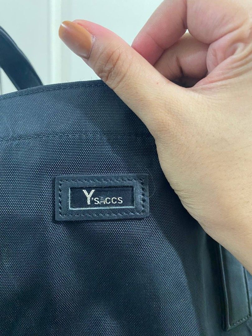 Y's Sacs Black Tote Bag (Category: Tote Bags) located in Manila. Submitted by aurafits (Listing ID 1434655790, Image 3). Description: Excellent condition - Y's Sacs black tote bag - Zippered main compartment - Multiple interior pockets - Leather handles - Small logo detail - Durable, water-resistant material - Black interior lining - Secure zipper closure.