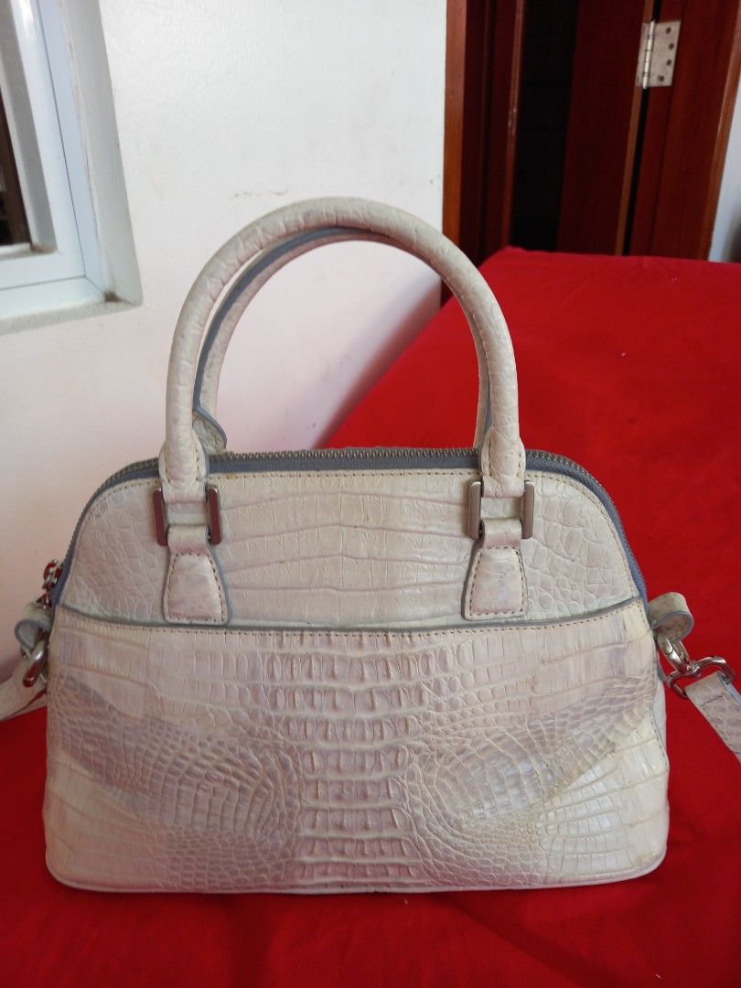 Zarmoi Crocodile Leather Handbag (Category: Luxury Bags & Wallets) located in Tuguegarao City. Submitted by zenphoenix-7ad615 (Listing ID 1434691364, Image 1). Description: - Zarmoi handbag - Crocodile-embossed leather - Top handle and detachable shoulder strap - Zip closure - Silver-tone hardware - Contrasting blue interior lining - Unique crocodile skin texture - Brand name visible on hardware adjustable sling can be shoulder or cross body bag.