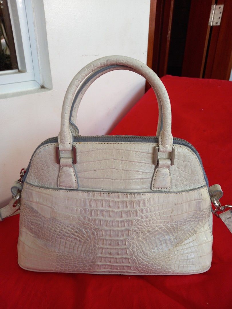 Zarmoi Crocodile Leather Handbag (Category: Luxury Bags & Wallets) located in Tuguegarao City. Submitted by zenphoenix-7ad615 (Listing ID 1434691364, Image 2). Description: - Zarmoi handbag - Crocodile-embossed leather - Top handle and detachable shoulder strap - Zip closure - Silver-tone hardware - Contrasting blue interior lining - Unique crocodile skin texture - Brand name visible on hardware adjustable sling can be shoulder or cross body bag.