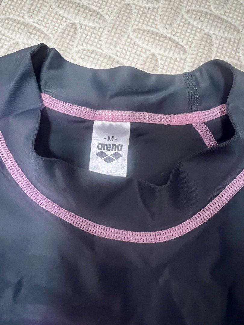 Arena Rash Guard - Black and Pink (Category: Rash guard) located in Malabon City. Submitted by bini_mini (Listing ID 1434905089, Image 2). Description: - Arena rash guard - Color: Black with pink stitching - Size: M - Features Arena logo - Long-sleeved - Perfect for swimming and water activities - Stretchy material - Provides sun protection.