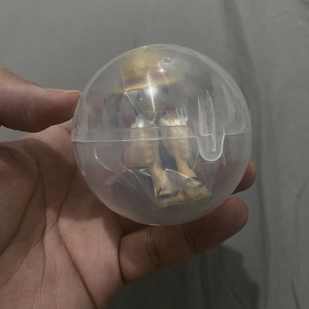 Bandai Gashapon One Piece Still Waiting For You Luffy Figure (Category: Figurines & Statues) located in Makati City. Submitted by hyperdrive_mnl (Listing ID 1434936816, Image 2). Description: - Bandai One Piece figure: Luffy - Pose: Luffy sitting with a spoon and fork - Includes: Original capsule - Packaging: Displays other figures from the collection - Height: Approximately 15.2 cm.