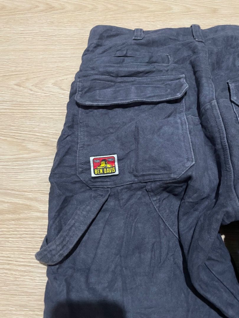 Ben Davis Cargo Pants (Category: Jeans) located in Sorsogon. Submitted by solayram0114595 (Listing ID 1434895572, Image 3). Description: - Ben Davis cargo pants - Multiple pockets: two front with zipper, two back, two side - Classic workwear style - Features Ben Davis logo patch - Made from sturdy, dark-colored fabric.