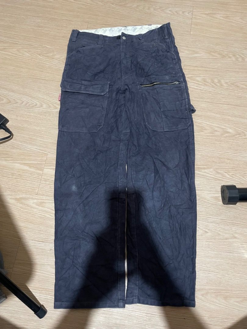 Ben Davis Cargo Pants (Category: Jeans) located in Sorsogon. Submitted by solayram0114595 (Listing ID 1434895572, Image 2). Description: - Ben Davis cargo pants - Multiple pockets: two front with zipper, two back, two side - Classic workwear style - Features Ben Davis logo patch - Made from sturdy, dark-colored fabric.