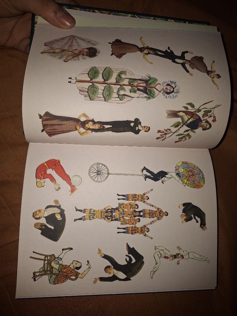Bibliophilia Antiquarian Sticker Book (Category: Storybooks) located in Manila. Submitted by keenfish-40b7 (Listing ID 1434951643, Image 3). Description: - Vintage-style sticker book - Features illustrations of butterflies, circus performers, and whimsical characters - Teal cover with gold accents - Contains numerous sticker pages - Ideal for crafting, scrapbooking, and collecting.