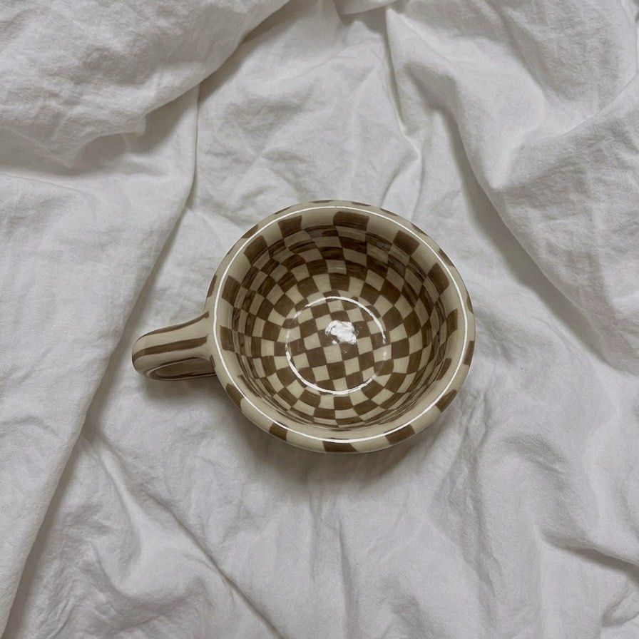 Brown Checkered Ceramic Aesthetic Coffee Mug (Category: Coffee & Tea Tableware) located in Manila. Submitted by chlo_things (Listing ID 1434950356, Image 2). Description: - Ceramic mug with a unique checkered design (brown and cream). - Comfortable handle for easy grip. - Rounded shape. - Well-crafted and stylish. - Ideal for coffee, tea, or any beverage. - A great addition to your kitchen or mug collection. 📍 Location: Quezon City (QC) 🚚 Shipp