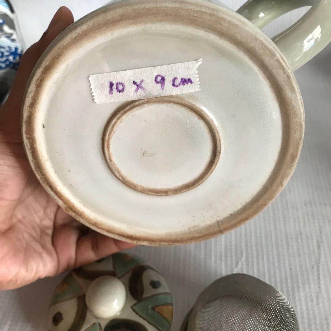 Ceramic Teapot with Geometric Design #4521 (Category: Coffee & Tea Tableware) located in Malabon City. Submitted by mldg.surplus (Listing ID 1434896383, Image 3). Description: - Ceramic teapot with a unique geometric design - Includes a removable strainer - Dimensions: 10 x 9 cm - Features a handle and spout - Condition: Hairline crack at the bottom MLDG Surplus Reminder: •Expect minimal flaws such as stain, lint, scratches etc. •No reservation, 