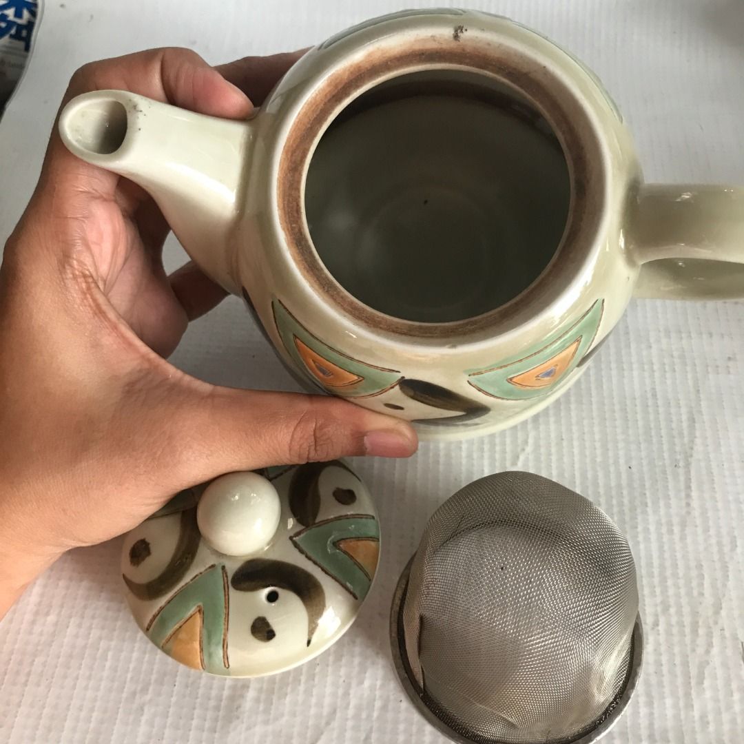 Ceramic Teapot with Geometric Design #4521 (Category: Coffee & Tea Tableware) located in Malabon City. Submitted by mldg.surplus (Listing ID 1434896383, Image 2). Description: - Ceramic teapot with a unique geometric design - Includes a removable strainer - Dimensions: 10 x 9 cm - Features a handle and spout - Condition: Hairline crack at the bottom MLDG Surplus Reminder: •Expect minimal flaws such as stain, lint, scratches etc. •No reservation, 