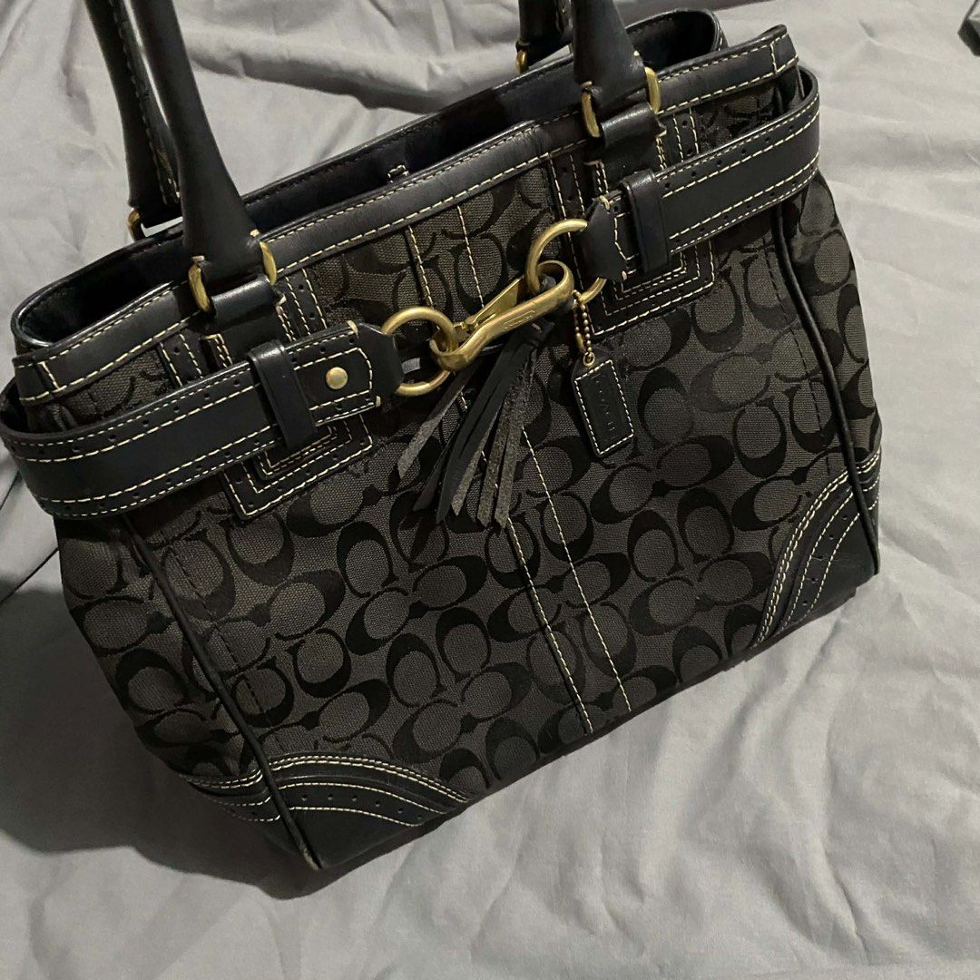 Coach Black Signature Handbag (Category: Luxury Bags & Wallets) located in Bacolod City. Submitted by unkemptrags (Listing ID 1434951545, Image 2). Description: - Authentic Coach handbag - Black with signature C pattern - Rank AB - Issue Minimal sign of use - Features leather accents - Double handles - Decorative tassel - Gold-tone clasp and hardware - Interior Coach tag with serial number L0673-10509 - Structured shape with stitched design 3,499