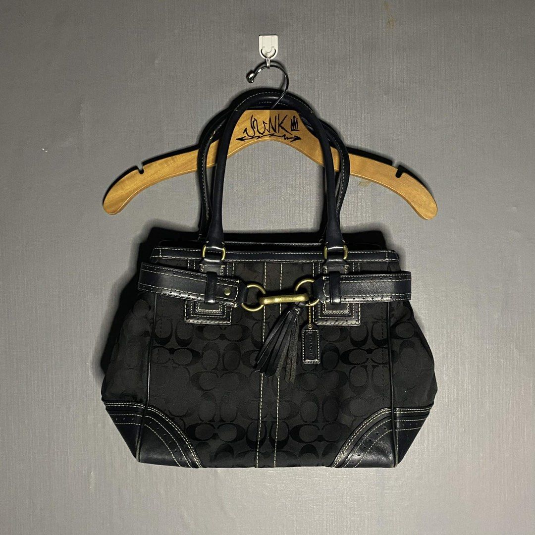 Coach Black Signature Handbag (Category: Luxury Bags & Wallets) located in Bacolod City. Submitted by unkemptrags (Listing ID 1434951545, Image 1). Description: - Authentic Coach handbag - Black with signature C pattern - Rank AB - Issue Minimal sign of use - Features leather accents - Double handles - Decorative tassel - Gold-tone clasp and hardware - Interior Coach tag with serial number L0673-10509 - Structured shape with stitched design 3,499