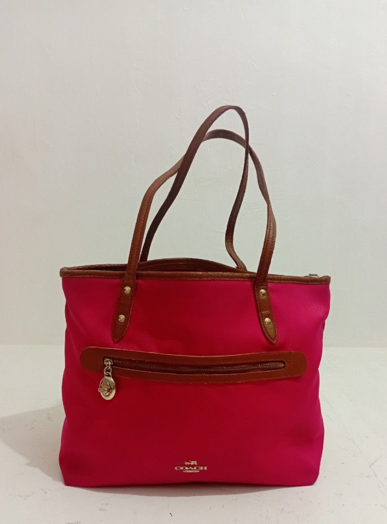 Original Coach SAWYER Tote Bag (Category: Luxury Bags & Wallets) located in Manila. Submitted by eriiicaspage (Listing ID 1434939623, Image 2). Description: PreOwned WellUsed Coach Sawyer tote bag - Vibrant pink exterior - Brown leather accents - Zip closure - Dual top handles - Small Coach logo - Brown base - Medium size Sign of Used flaws : Sign of Used sa innerlining ,May ilang Part na Sticky sa leather Strap Good Condition 8.8/10 - Ideal for 