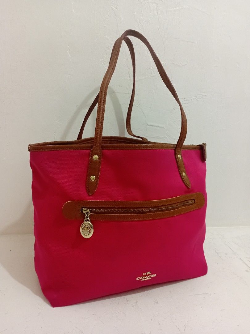 Original Coach SAWYER Tote Bag (Category: Luxury Bags & Wallets) located in Manila. Submitted by eriiicaspage (Listing ID 1434939623, Image 3). Description: PreOwned WellUsed Coach Sawyer tote bag - Vibrant pink exterior - Brown leather accents - Zip closure - Dual top handles - Small Coach logo - Brown base - Medium size Sign of Used flaws : Sign of Used sa innerlining ,May ilang Part na Sticky sa leather Strap Good Condition 8.8/10 - Ideal for 