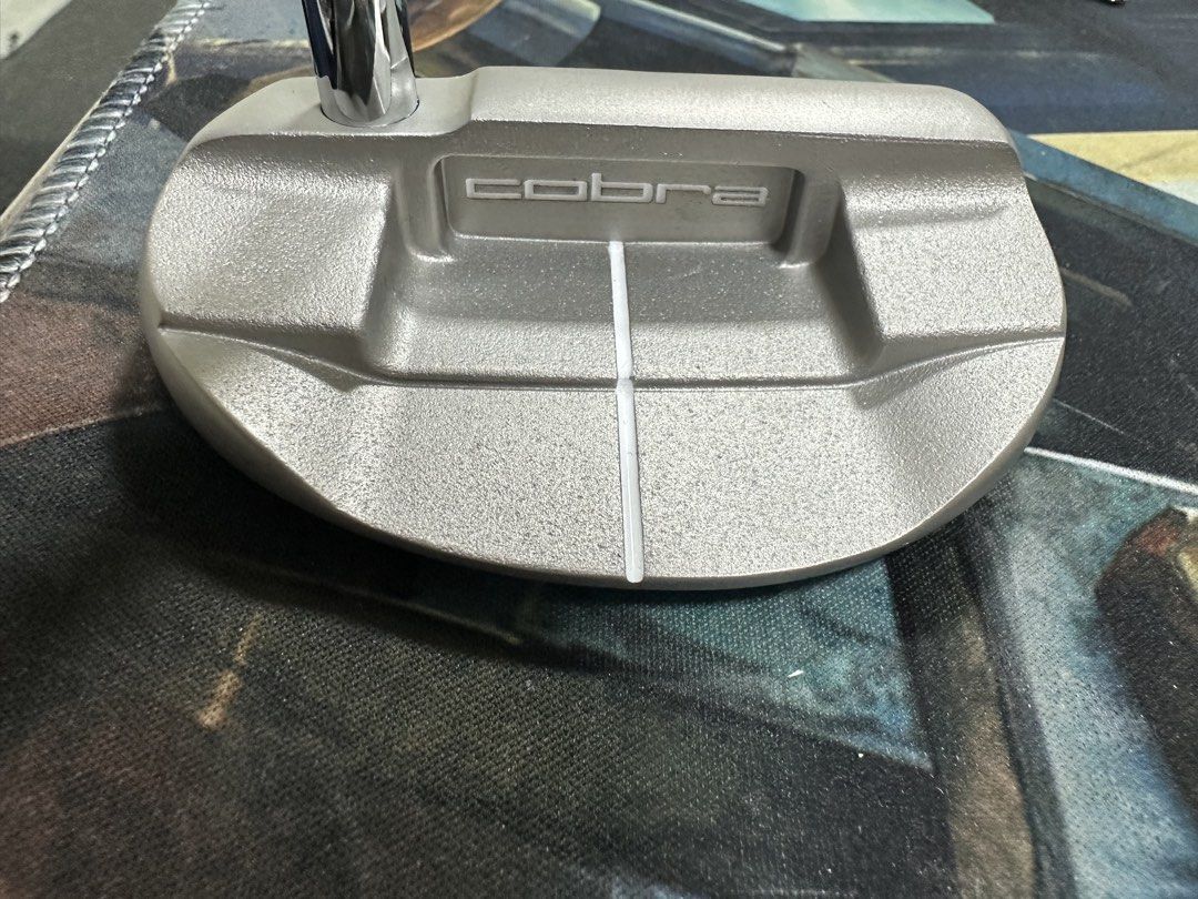 Cobra Golf Putter (Category: Golf) located in Bacoor. Submitted by oreoyo (Listing ID 1434808954, Image 2). Description: Cobra golf putter features a silver finish and a distinctive grip. The putter head has a white alignment line. The Cobra logo is visible on the putter head and the grip. The putter has a straight shaft design..