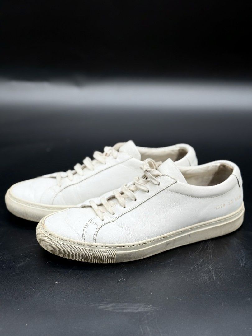 Common Projects White Leather Sneakers (Category: Sneakers) located in Quezon City. Submitted by opulist (Listing ID 1434969441, Image 1). Description: - 100% AUTHENTIC Common Projects white leather sneakers - Size 39 - Low-profile silhouette - Rubber sole - Signs of wear on soles and leather - Serial number visible.