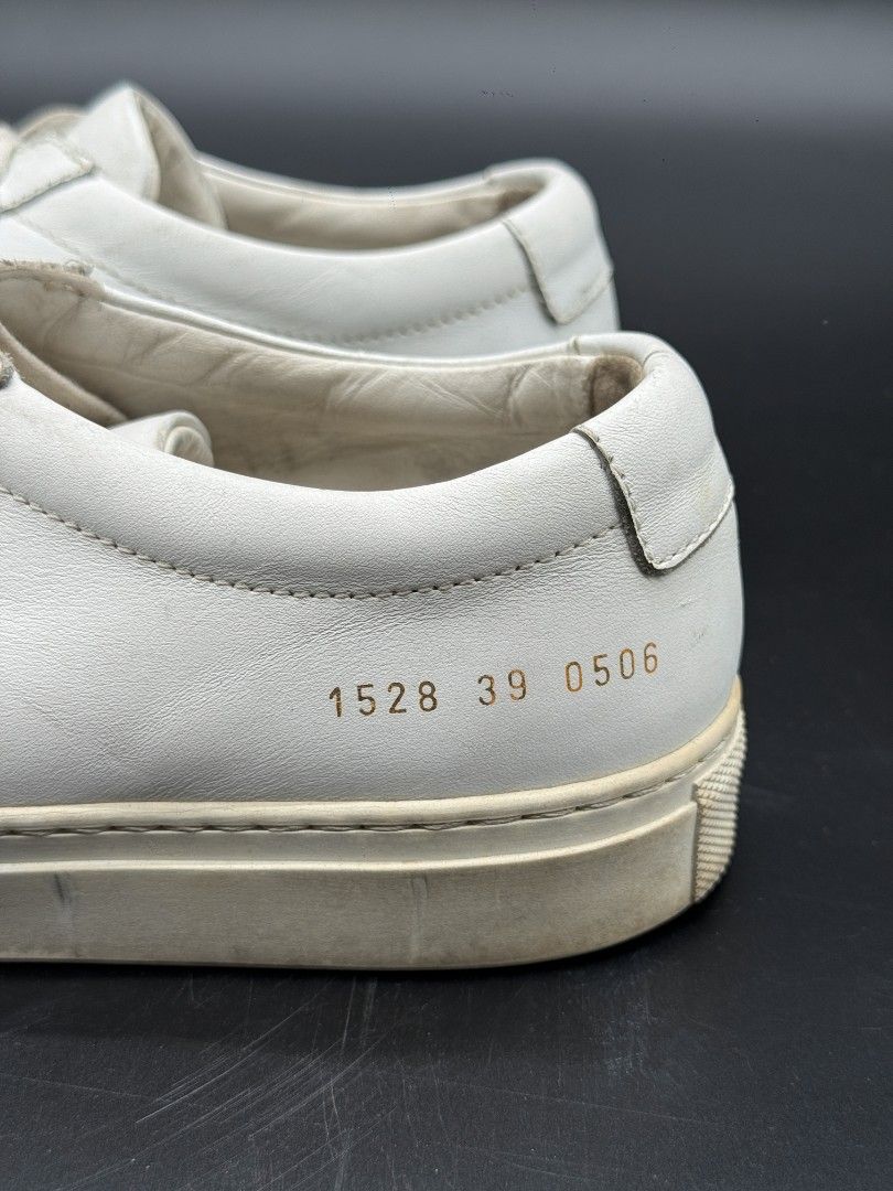 Common Projects White Leather Sneakers (Category: Sneakers) located in Quezon City. Submitted by opulist (Listing ID 1434969441, Image 2). Description: - 100% AUTHENTIC Common Projects white leather sneakers - Size 39 - Low-profile silhouette - Rubber sole - Signs of wear on soles and leather - Serial number visible.