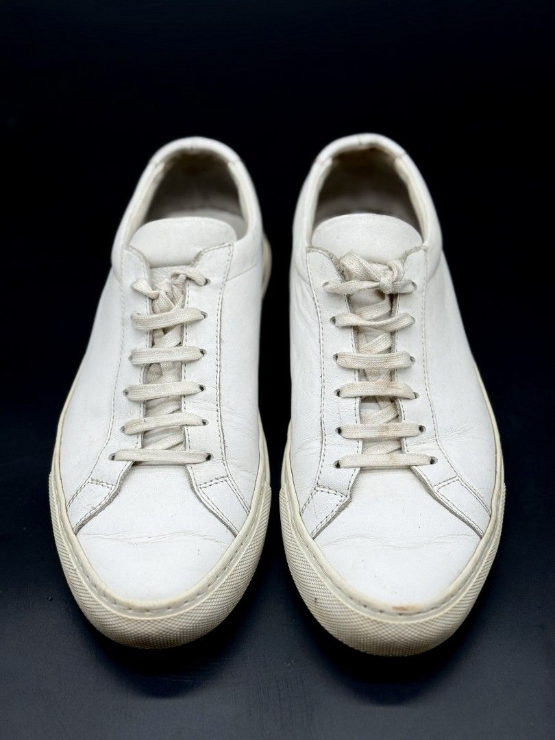 Common Projects White Leather Sneakers (Category: Sneakers) located in Quezon City. Submitted by opulist (Listing ID 1434969441, Image 3). Description: - 100% AUTHENTIC Common Projects white leather sneakers - Size 39 - Low-profile silhouette - Rubber sole - Signs of wear on soles and leather - Serial number visible.