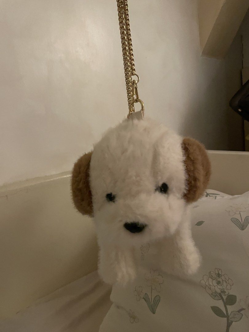 Dog-Shaped Handbag with Chain Strap (Category: Purses & Pouches) located in Makati City. Submitted by kzisdeclutter (Listing ID 1434995329, Image 3). Description: - Adorable dog-shaped handbag - Features a fluffy white body - Brown ears and tail detail - Gold chain strap - Secure zipper closure - Adds a playful touch to any outfit - Unique and eye-catching accessory.