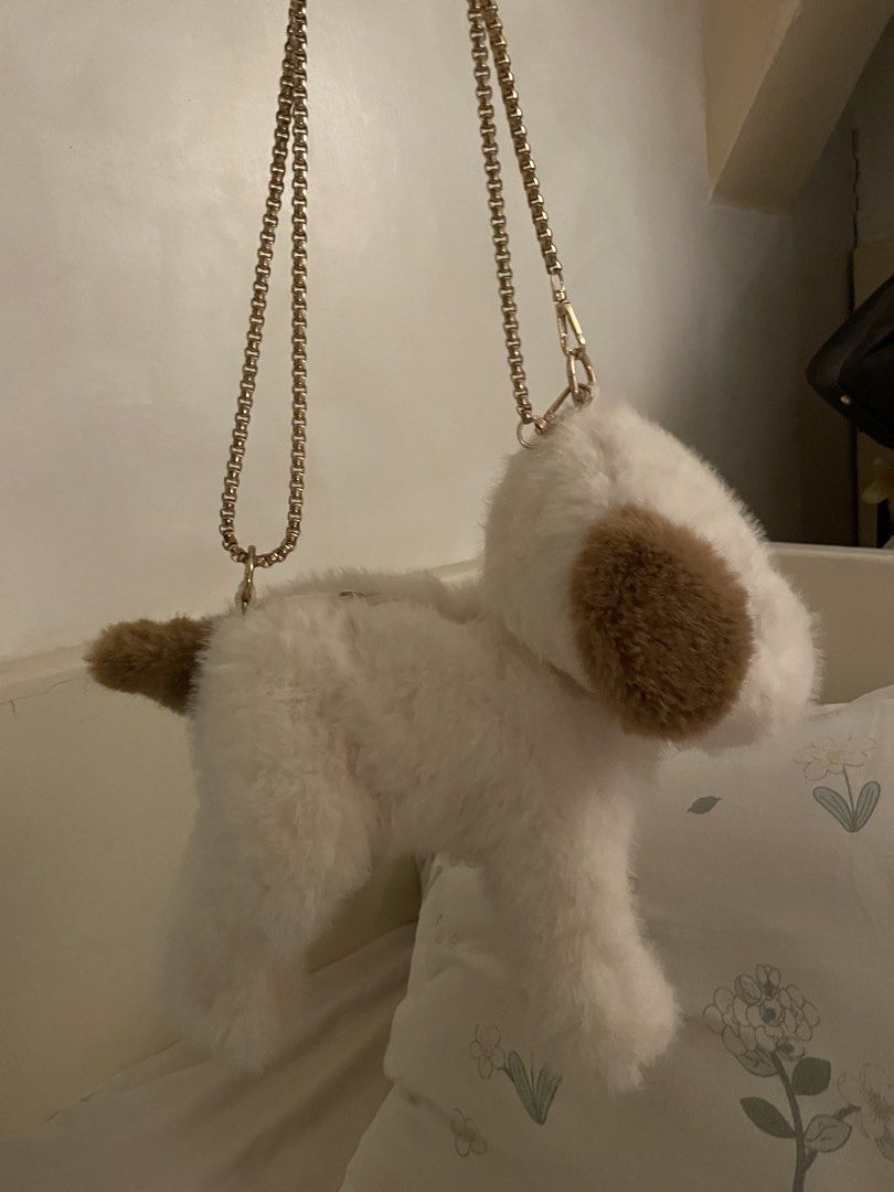 Dog-Shaped Handbag with Chain Strap (Category: Purses & Pouches) located in Makati City. Submitted by kzisdeclutter (Listing ID 1434995329, Image 2). Description: - Adorable dog-shaped handbag - Features a fluffy white body - Brown ears and tail detail - Gold chain strap - Secure zipper closure - Adds a playful touch to any outfit - Unique and eye-catching accessory.