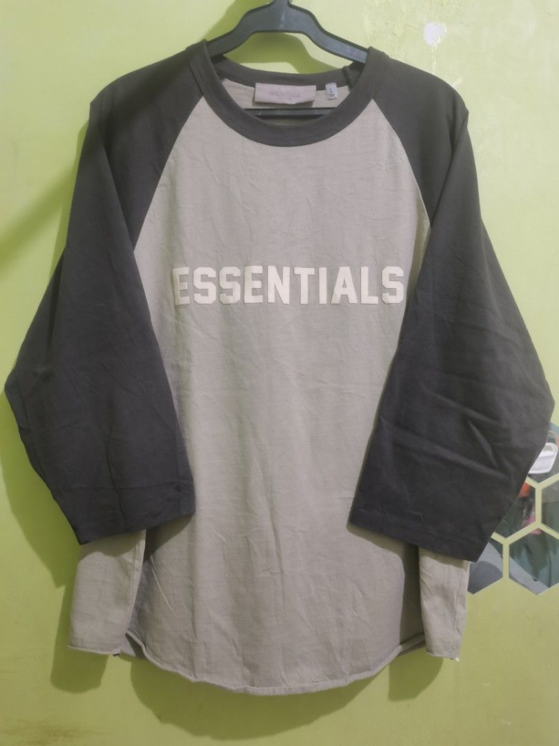 Essentials Fear of God Raglan Shirt - Large (Category: Tshirts & Polo Shirts ) located in Quezon City. Submitted by elihur.tuazon (Listing ID 1434972670, Image 1). Description: - Essentials Fear of God raglan shirt - Neutral color with dark sleeves - Features the "Essentials" logo - Size: Large - Material: 100% cotton.