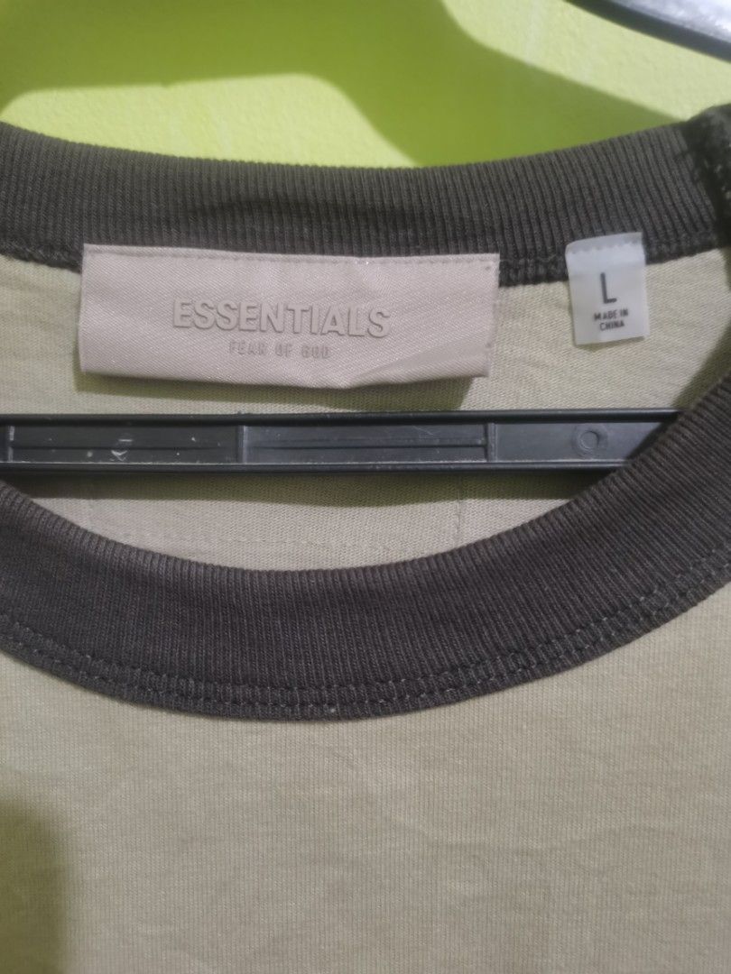 Essentials Fear of God Raglan Shirt - Large (Category: Tshirts & Polo Shirts ) located in Quezon City. Submitted by elihur.tuazon (Listing ID 1434972670, Image 3). Description: - Essentials Fear of God raglan shirt - Neutral color with dark sleeves - Features the "Essentials" logo - Size: Large - Material: 100% cotton.