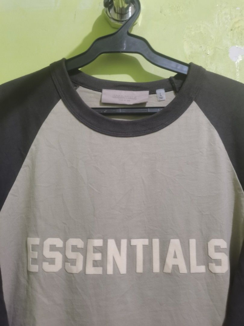 Essentials Fear of God Raglan Shirt - Large (Category: Tshirts & Polo Shirts ) located in Quezon City. Submitted by elihur.tuazon (Listing ID 1434972670, Image 2). Description: - Essentials Fear of God raglan shirt - Neutral color with dark sleeves - Features the "Essentials" logo - Size: Large - Material: 100% cotton.
