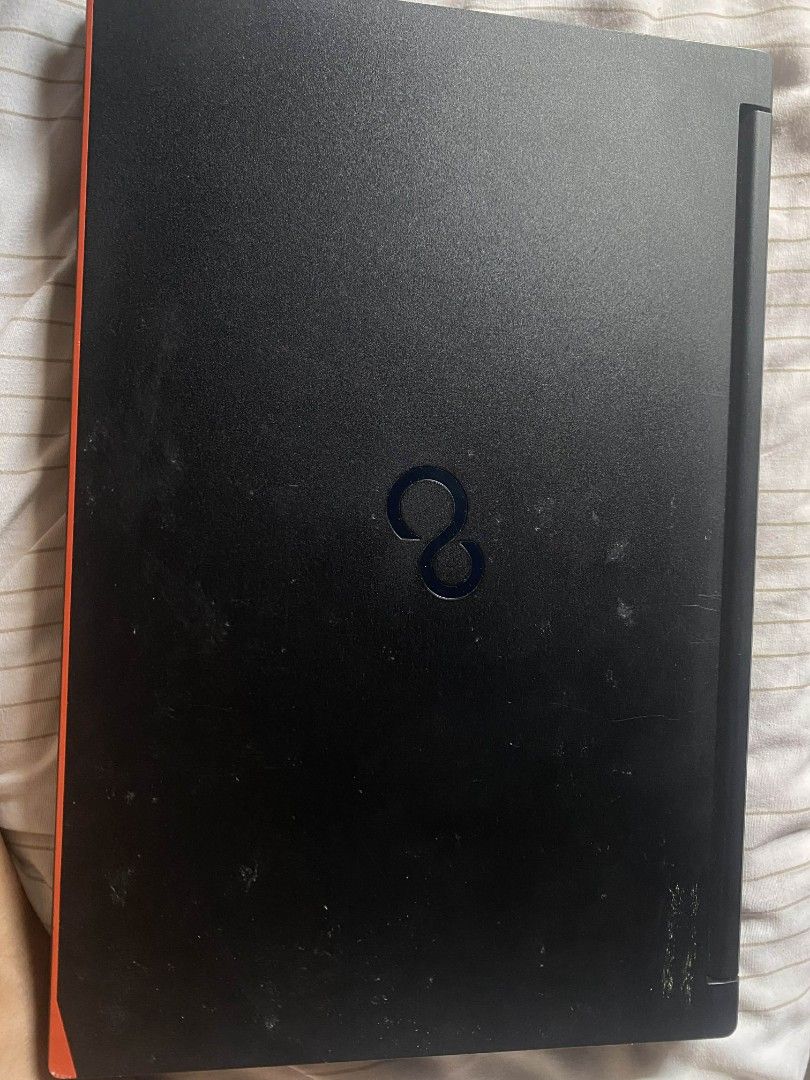 Fujitsu Laptop (Category: Laptops & Notebooks) located in Manila. Submitted by maggeee (Listing ID 1434934799, Image 2). Description: - Fujitsu laptop - Black body with red accents - Working and gaming condition - Screen displays time and date - Fujitsu logo visible -Good as new -Fast -1tb memory card Inclusion: -Charger -Web Cam -Laptop Bag Issue: Need replace the battery.
