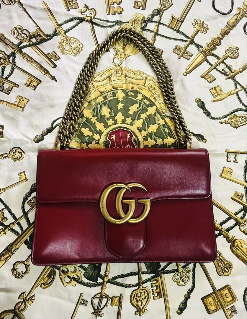 Gucci GG Marmont Shoulder Bag (Category: Luxury Bags & Wallets) located in Iloilo. Submitted by yangfire (Listing ID 1434893645, Image 1). Description: - PreLoved Gucci GG Marmont shoulder bag - Red leather exterior - Gold-tone chain strap - Iconic GG logo - Interior zipper pocket - Gucci logo and serial number tag - Structured design with multiple compartment - 7/10 (sign of use) iL be selling the bag for a lower price for the buyer to restore t