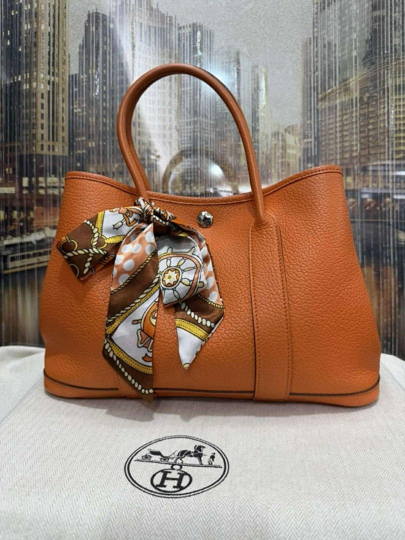 Hermes Garden Party Orange Handbag (Category: Luxury Bags & Wallets) located in Manila. Submitted by larascollection0920 (Listing ID 1434824696, Image 1). Description: Orange Hermes Garden Party handbag. Features a top handle design and a decorative scarf tied to the handle. The bag has a spacious interior. Includes a dust bag. 101% Guaranteed Authentic! .