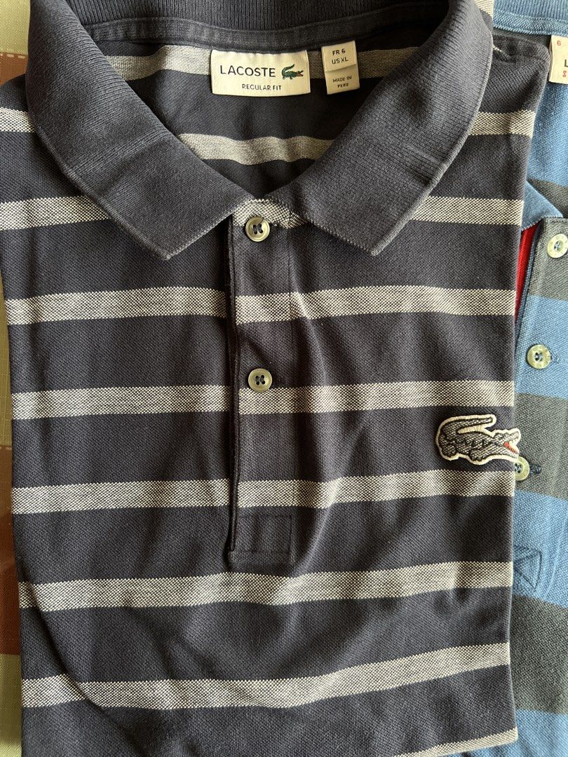 Lacoste Striped Polo Shirts (Category: Tshirts & Polo Shirts ) located in Quezon City. Submitted by stashandstuff (Listing ID 1434899551, Image 2). Description: -Preloved; 100% original - Shirt 1: Blue and grey, "SPORT" label. - Shirt 2: Navy and grey, "REGULAR FIT" label. - Take 2 for only 2800 .