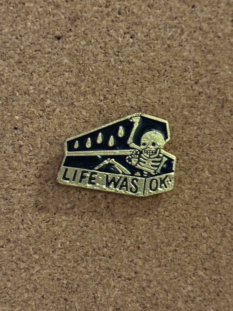 Life Was OK Skeleton Coffin Pin (Category: Vintage Collectibles) located in Manila. Submitted by chombyyy (Listing ID 1434882556, Image 1). Description: - Gold and black pin. - Features a skeleton in a coffin. - Includes the text "LIFE WAS OK". - Perfect for bags, jackets, and more. - Ideal for those who love alternative and quirky designs..