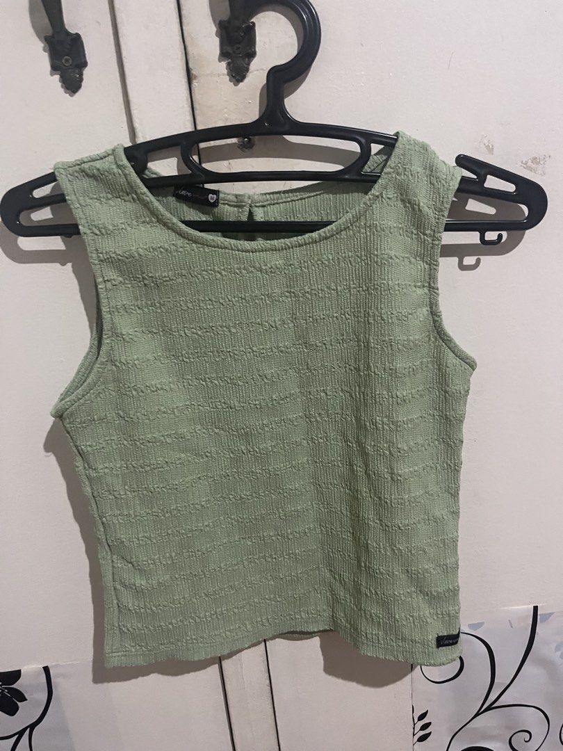 Love, Chloe Green Sleeveless Top (Category: Sleeveless) located in Manila. Submitted by thelineshopp (Listing ID 1434959765, Image 1). Description: - Love, Chloe brand - Green sleeveless top - Textured fabric - Round neckline - Small button closure at the back - Versatile wardrobe piece.