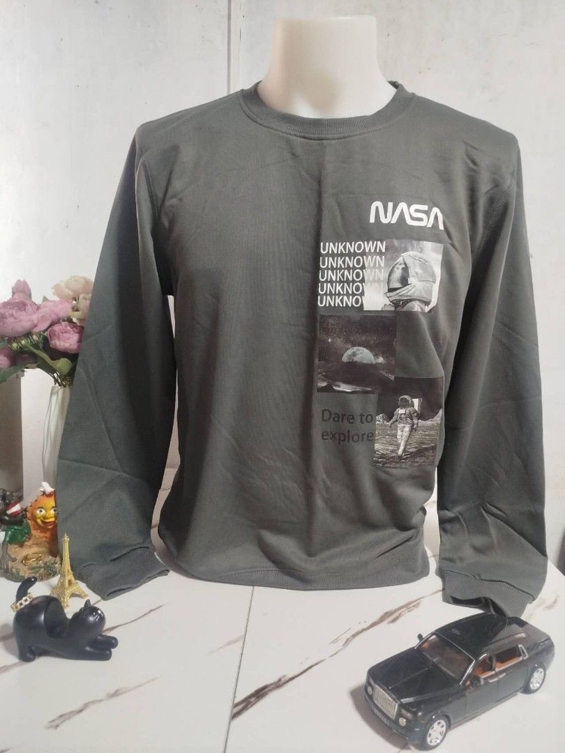NASA Long Sleeve Shirt (Category: Tshirts & Polo Shirts ) located in Mandaluyong City. Submitted by allinthehood (Listing ID 1434887877, Image 1). Description: - Dark grey long sleeve shirt - Features a NASA logo - Graphic design on the front - Design includes the words "UNKNOWN" - Also includes "Dare to explore".